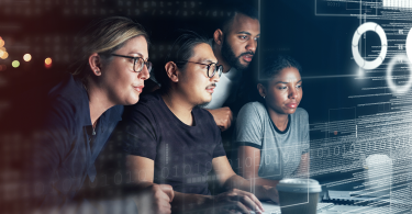 4-people-looking-at-binary-code screen-1400x700